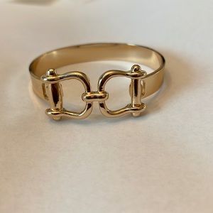 Gold plated Horsebit bangle bracelet with hook clasp closure
